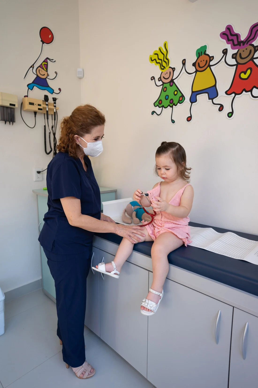 A nurse examining a toddler